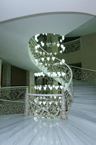 a room with a chandelier in the middle of a building at Spring Hotel in Novxanı