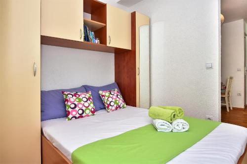 a bedroom with a bed with two towels on it at Apartment Borna in Makarska