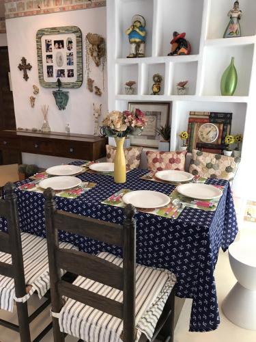 a dining room table with a blue and white table cloth at Mexican Beachfront Condo in Khao Tao