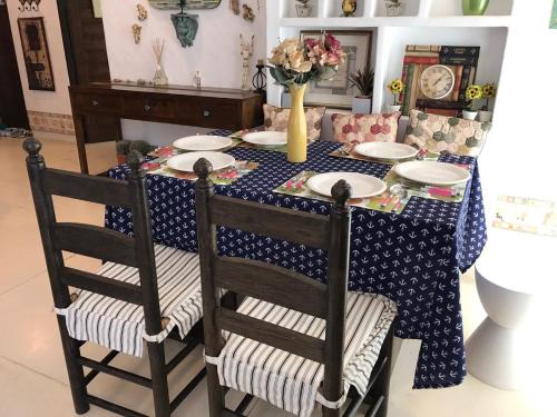 a dining room table with a blue and white table cloth at Mexican Beachfront Condo in Khao Tao