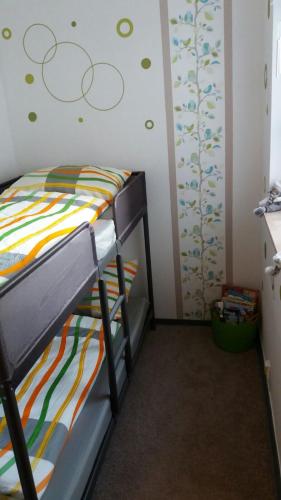 a bedroom with a bunk bed with a colorful bedspread at Haus Isabelle EG in Sankt Andreasberg