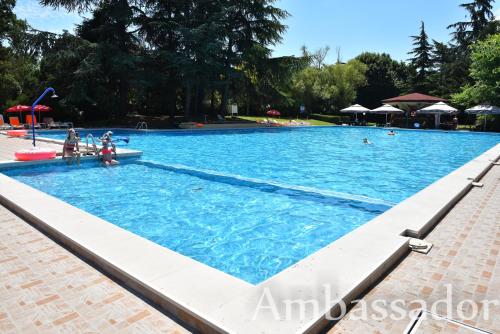 a large swimming pool with people in the water at Hotel Ambassador - Free Parking in Golden Sands