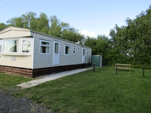 a tiny house sitting on top of a grass field at Fenlake holiday accommodation in Metheringham