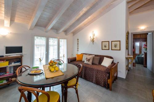 a living room with a table and a couch at Mansarda Lina in Casarza Ligure