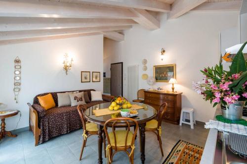 a living room with a couch and a table at Mansarda Lina in Casarza Ligure