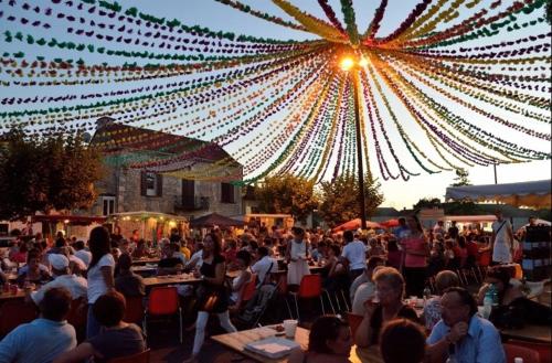 a crowd of people sitting at tables under a bunch of lights at Labarthe in Baleyssagues