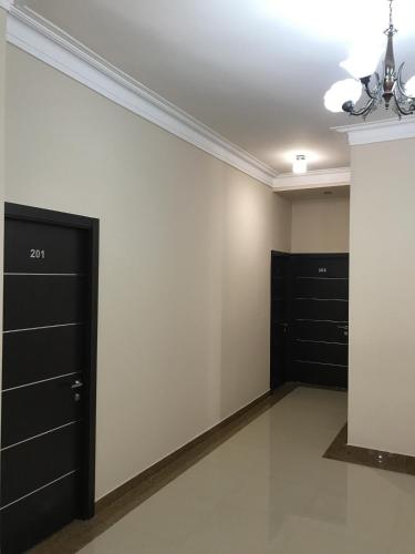 a room with black drawers and a white wall at Capital Hotel in Yerevan