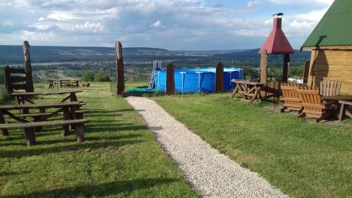 a group of picnic tables and a playground at Noclegi u Banysia w sercu Gór Świętokrzyskich in Krajno Pierwsze