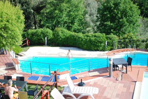 a swimming pool with a person in the middle of it at Borgo La Casaccia in Montaione