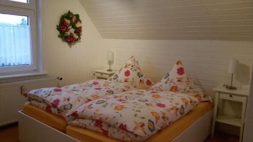 a bedroom with a bed with a wreath on the wall at Haus Isabelle OG in Sankt Andreasberg