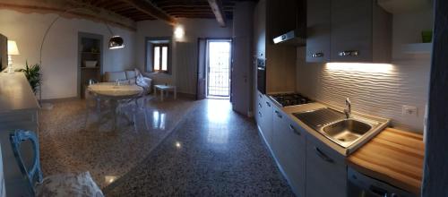 a kitchen with a sink and a table in it at Montevenere 83 in Chiusi