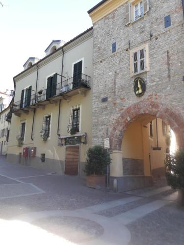 a large stone building with an arch in front of it at Casa Pisterna in Acqui Terme