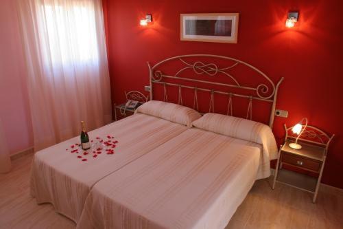 a red bedroom with a bed with a red wall at Hotel Restaurante Casa Julia in Parcent