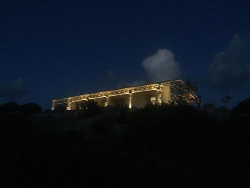 a white building lit up at night at Stazzo Serafini in Rena Majore