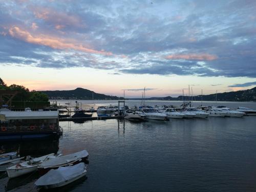 a group of boats docked in a marina at sunset at Hotel Capri in Lesa