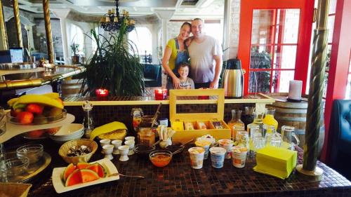 a family standing in a kitchen with a table with food at my CITY HOTEL in Eisenberg