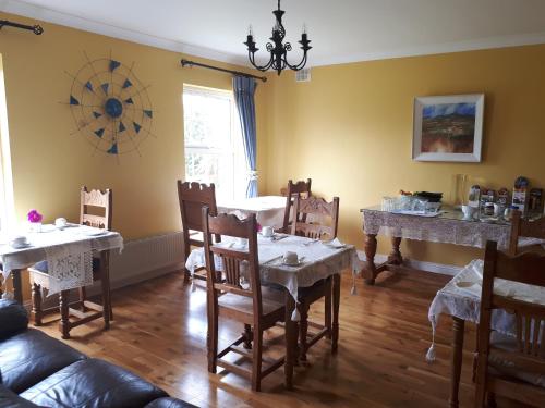a living room with a table and chairs and a dining room at The Creggs in Ballyvaughan