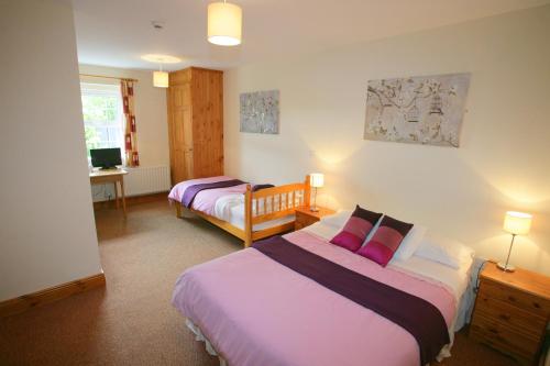 a bedroom with two beds and a tv in it at Cottage Heights in Castletownbere