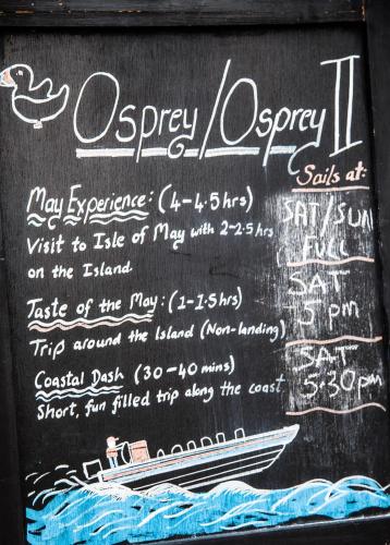 a chalkboard with a sign with a boat on it at Auld Leigh-Lann Apartments in Anstruther