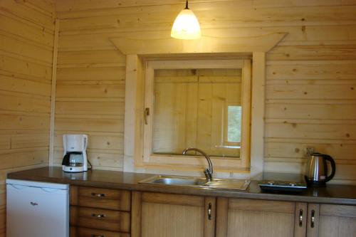 a kitchen with a sink and a window at Villa Róża in Kamesznica