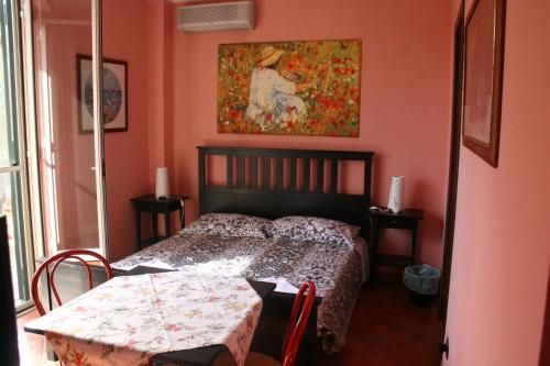a bedroom with a bed and a painting on the wall at B&B Etna Country in Tremestieri Etneo