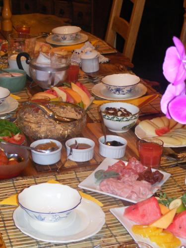 a table topped with plates and bowls of food at Casa Marchi in Bagni di Lucca
