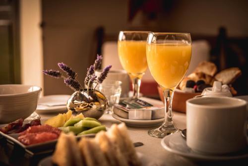 a table with two glasses of orange juice and bread at Casa del Sol Cafayate in Cafayate