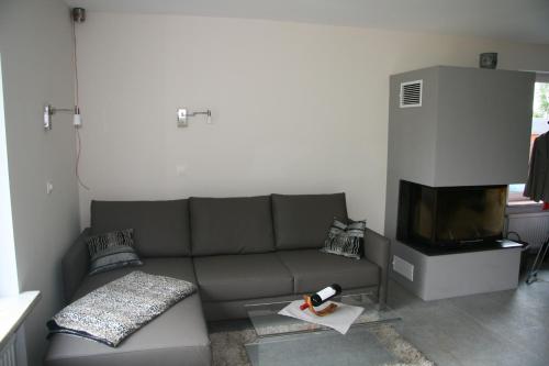 a living room with a couch and a tv at Ferienwohnung Kiel-Russee in Kiel