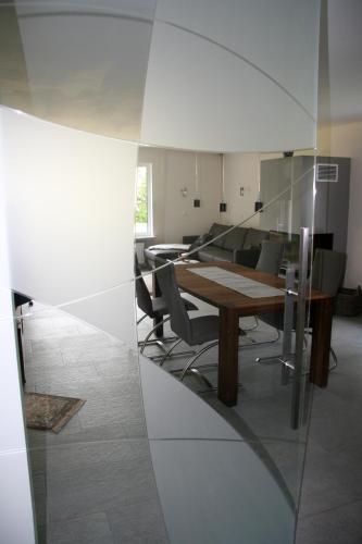 a conference room with a wooden table and chairs at Ferienwohnung Kiel-Russee in Kiel