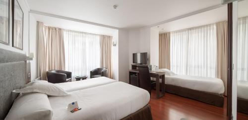 Postel nebo postele na pokoji v ubytování Hotel Yoldi