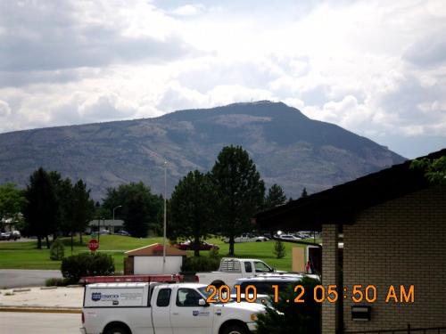 a white truck parked in front of a mountain at Green Gables Inn in Cody