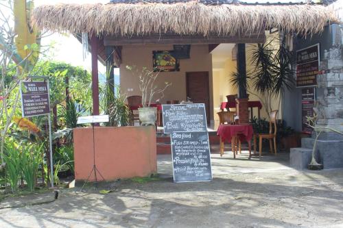 a restaurant with a sign in front of a building at Maha Neka Villa in Sidemen