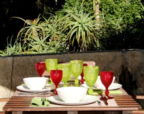a table with red and green wine glasses on it at Quinta do Casal de Santo António in Alenquer