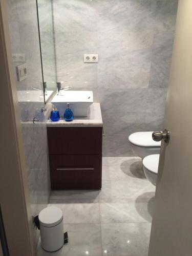 a bathroom with a sink and a toilet and a mirror at Mirador De Begur in Begur