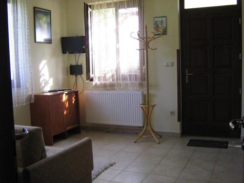 a living room with a door and a window at Patakparti Apartman in Bozsok