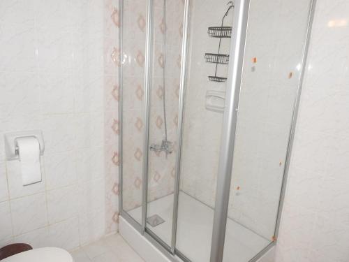 a shower stall in a bathroom with a toilet at Ertunalp Apartment in Mağusa