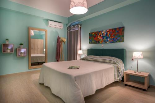 a bedroom with a large bed and a mirror at Stella in the Village Suites in Plakias