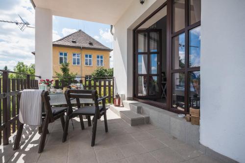 a patio with a table and chairs on a balcony at Penzion Labská Vyhlídka in Litoměřice