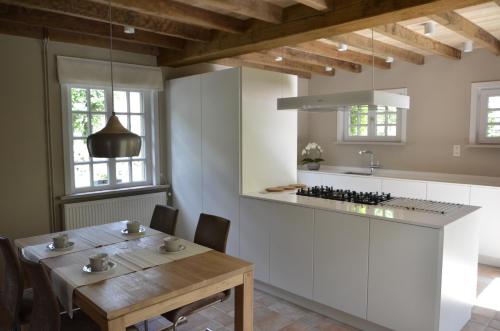 une cuisine avec une table en bois et une salle à manger dans l'établissement Vakantiewoning Wanderlust, à Alveringem