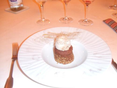 a white plate with a piece of food on a table at Masia d'en Valentí in Anserall
