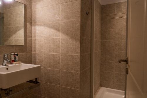 a bathroom with a sink and a shower at Porto Heli Villa in Porto Heli