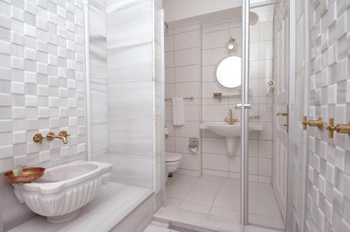 a bathroom with a shower and a toilet and a sink at Darussaade Hotel Old City - Sultanahmet in Istanbul
