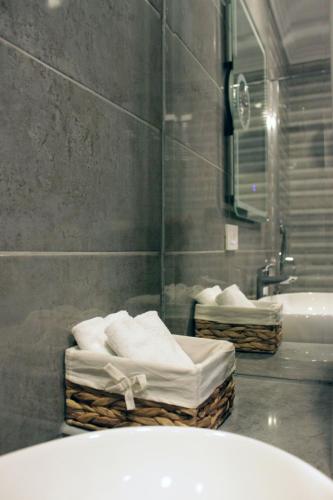 a bathroom with a tub and a sink and towels at Apartments O la la in Zagreb