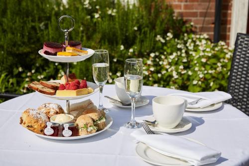 a table with plates of food and glasses of wine at Lismoyne Hotel in Fleet