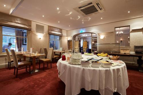 a dining room with a table with food on it at Lismoyne Hotel in Fleet