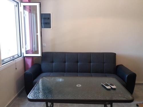 a blue couch in a room with a table at Belvedere Zakynthos Studios in Vasilikos