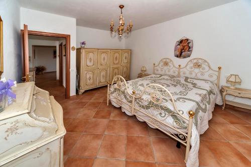 1 dormitorio con cama blanca y lámpara de araña en Lavanda Country House, en Pescia Romana