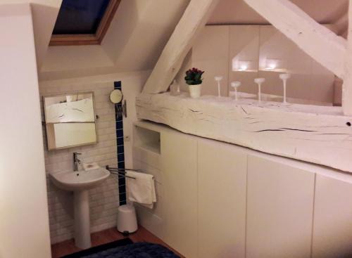 a bathroom with a sink and a toilet in a attic at La Cuvée-Saint-Georges in Nuits-Saint-Georges