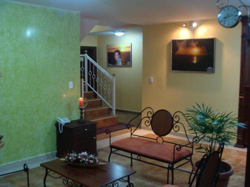 a living room with two chairs and a table at Hostal La Molienda in Puyo