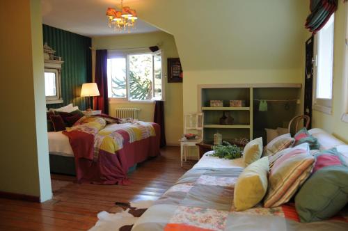 a bedroom with two beds and a room with two beds at Los Juncos Patagonian Lake House in San Carlos de Bariloche